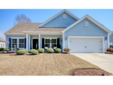 Charming single-story home featuring a well-manicured lawn, attached two-car garage, and traditional architectural details at 1439 Castleberry Pl., Myrtle Beach, SC 29588