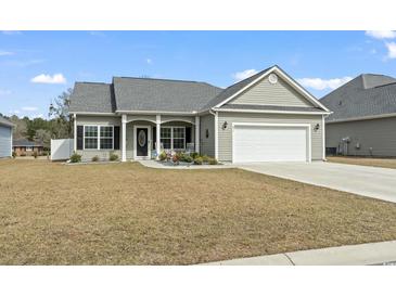 Charming single-story home with a well-maintained lawn, landscaping, and attached two car garage at 211 Copperwood Loop, Conway, SC 29526