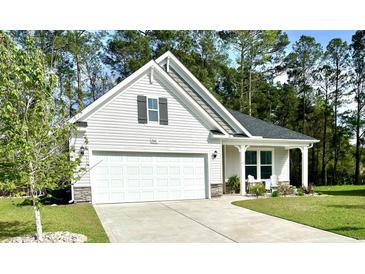 Charming home featuring a two-car garage, neutral siding, and a welcoming front porch at 2441 Capri Court, Conway, SC 29527