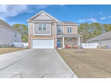 Charming two-story home with a two-car garage, inviting curb appeal, and a well-maintained lawn at 404 Cattle Drive Circle, Myrtle Beach, SC 29588