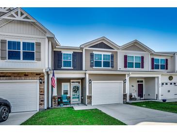 Charming townhomes featuring attached garages, covered front porches, and well-maintained lawns at 4123 Mclamb Ave. # 4123, Little River, SC 29566