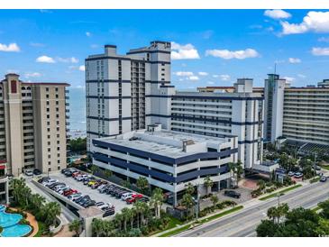 Aerial view of a resort with a multi-level parking garage and tropical landscaping at 5308 N Ocean Blvd. # 1003, Myrtle Beach, SC 29577