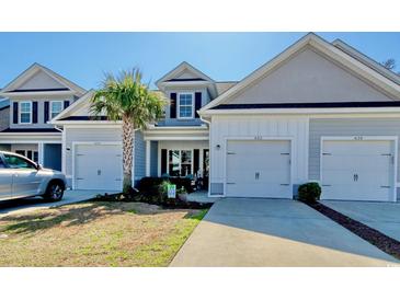 Charming townhome with a well-manicured lawn, attached garage and a welcoming entrance at 622 Lorenzo Dr. # 622, North Myrtle Beach, SC 29582