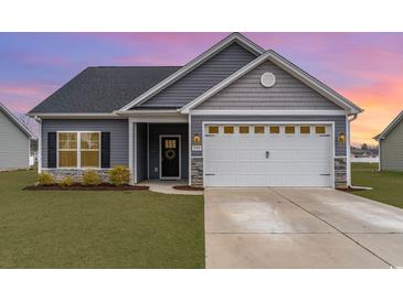 Charming single-story home with gray siding, a two-car garage, and a well-maintained lawn at 245 Maiden'S Choice Dr., Conway, SC 29527