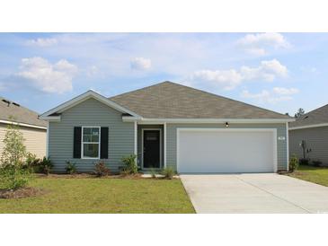 Charming single-story home with a well-manicured lawn and an attached one-car garage at 303 Clear Lake Dr., Conway, SC 29526