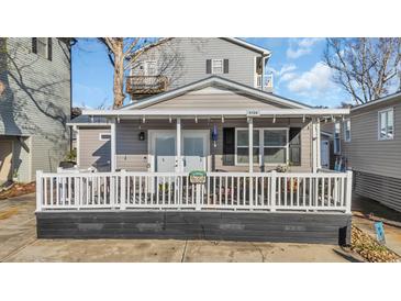 Charming gray cottage with white-railed porch, perfect for relaxing and enjoying the outdoors at 6001-5124 S Kings Hwy., Myrtle Beach, SC 29575