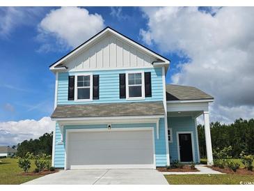 Charming two-story home with light blue siding, white trim, black shutters, and a two-car garage at 8081 Bear Claw Way, Conway, SC 29526