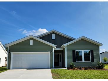 Charming single-story home with green siding, attached garage, well-manicured lawn, and inviting curb appeal at 119 Bolsin Ct, Conway, SC 29526