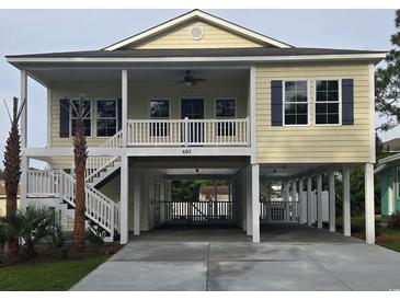 Inviting coastal home with covered parking, front porch, and staircase at 605 15Th Ave. S, North Myrtle Beach, SC 29582