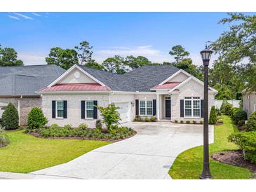 Charming one-story brick home featuring a well-manicured lawn, black shutters, and a cozy, inviting entrance at 870 Monterrosa Dr., Myrtle Beach, SC 29572