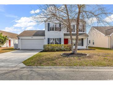 Charming two-story home with a well-maintained lawn, attached garage, and red front door at 2629 Scarecrow Way, Myrtle Beach, SC 29579