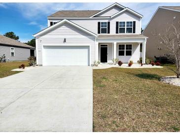 Charming two-story home with a two car garage, well-manicured lawn, and black shutters at 5088 Wavering Place Loop, Myrtle Beach, SC 29579