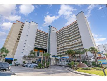 Low angle exterior shot of a beachfront resort featuring palm trees and direct access to the sandy shores at 5300 N Ocean Blvd. # 217, Myrtle Beach, SC 29577