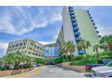 Resort complex featuring palm trees, manicured landscaping, and ample parking on a sunny day at 1105 South Ocean Blvd. # 208, Myrtle Beach, SC 29577