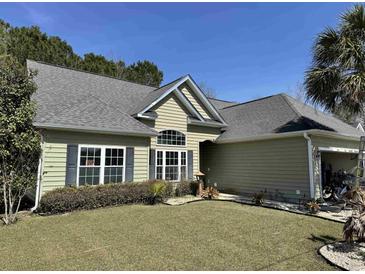 Charming single-story home features a well-manicured lawn and tidy landscaping for a welcoming curb appeal at 1210 Pecan Grove Blvd., Conway, SC 29527
