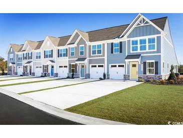Charming townhomes featuring colorful doors, stone accents, attached garages, and well-maintained landscaping at 2078 Nw Parow Ln Nw # B, Calabash, NC 28467
