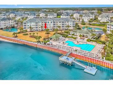Beautiful waterfront condo with a swimming pool, dock and manicured landscaping creating a luxurious and tranquil atmosphere at 2180 Waterview Dr. # 513, North Myrtle Beach, SC 29582