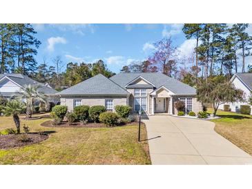 Charming single-story brick home with manicured landscaping and a spacious driveway at 4208 Edgefield Rd., Little River, SC 29566