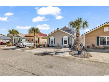 Charming single-story homes with colorful exteriors and well-maintained landscaping on a sunny day at 4350 Grande Harbour Blvd., Little River, SC 29566