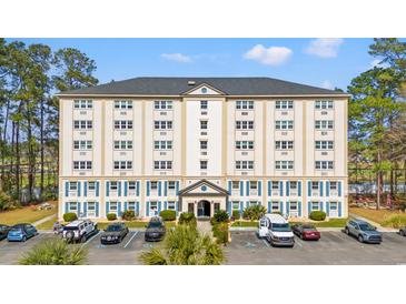 Six story building with neutral colors, black roof, and parking lot, surrounded by trees at 6850 Blue Heron Blvd. # 205, Myrtle Beach, SC 29588