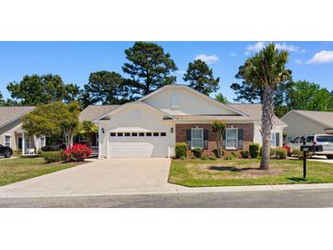 Charming single-story home with a two-car garage, brick accents, manicured lawn, and inviting curb appeal at 471 Deerfield Links Dr., Surfside Beach, SC 29575