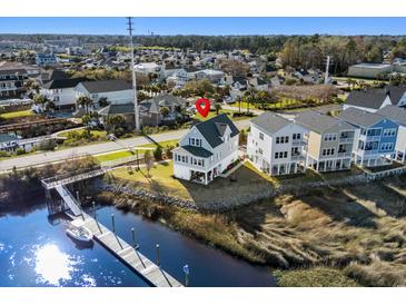Beautiful coastal home with charming architecture, waterfront views, and private dock at 100 Marblehead Dr., Little River, SC 29566