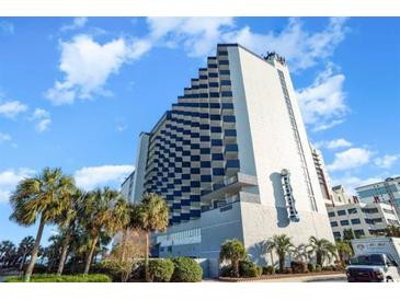 Striking exterior view of the hotel with blue-gray balconies and palm trees under a bright blue sky at 2001 S Ocean Blvd. # 1505, Myrtle Beach, SC 29577