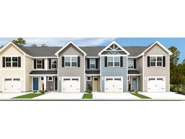 Charming townhome exteriors showcase a mix of colors and attached garages at 262 Christiana Ln. # E, Myrtle Beach, SC 29579