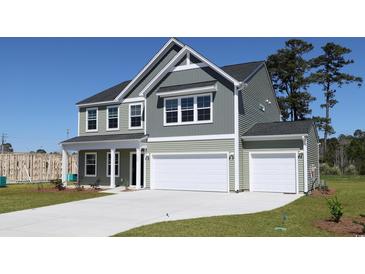 Charming two-story home with a two car garage and inviting curb appeal at 324 Mayflower Dr., Calabash, NC 28467