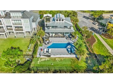 Stunning aerial view of a home with a pool, manicured backyard, outdoor kitchen, and palm trees at 3806 North Ocean Blvd., Myrtle Beach, SC 29577