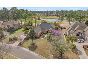 Stunning aerial view of a brick home on a golf course with mature trees and beautiful landscaping at 4222 Congressional Dr., Myrtle Beach, SC 29579