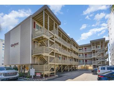 Beautiful multi-level beach condo with outdoor stairs and wood facade near the ocean and under sunny skies at 4305 S Ocean Blvd. # 301, North Myrtle Beach, SC 29582