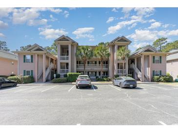 Inviting condo complex featuring covered balconies, lush landscaping and ample parking at 478 Pinehurst Ln. # 17D, Pawleys Island, SC 29585