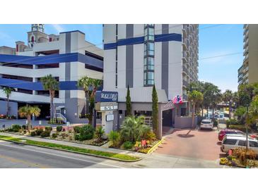 Modern condo building with a gray and white facade, palm trees, and covered parking at 5308 N Ocean Blvd. # 503, Myrtle Beach, SC 29577