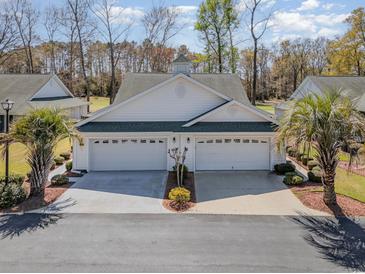 Charming villa with a pristine white facade, dual garages, and lush palm trees at 640 Intracoastal Way # 640, Myrtle Beach, SC 29579