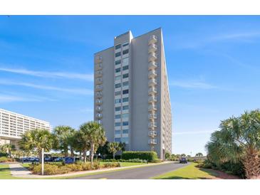 Stunning exterior view of a high-rise condo building with balconies and manicured landscaping in a lush community at 9820 Queensway Blvd. # 1210, Myrtle Beach, SC 29572