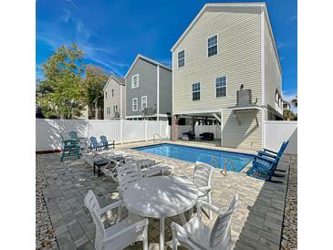 Inviting backyard pool with ample seating, perfect for relaxing and entertaining with a privacy fence surround at 113B 15Th Ave. S, Surfside Beach, SC 29575