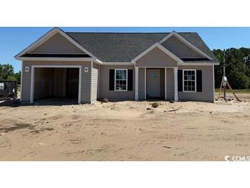 Charming single-story home featuring a garage, neutral siding, and classic black shutters at 1280 Highway 45, Loris, SC 29569