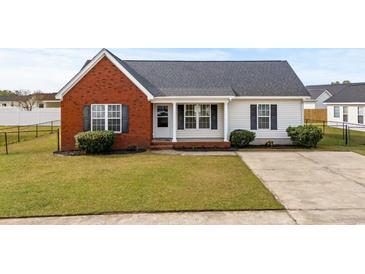 Charming one-story home featuring brick facade and well-manicured lawn in a Gathering-friendly neighborhood at 1113 Green Fir Loop, Conway, SC 29527