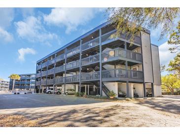 This four-story building has wood and steel accents, multiple balconies, and convenient covered parking at 1500 Cenith Dr. # E302, North Myrtle Beach, SC 29582