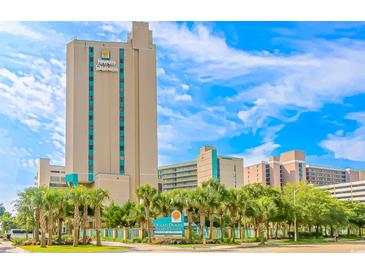 Sand Dunes Resort, a tall, luxurious building, under a partly cloudy bright blue sky at 205 74Th Ave. N # 904, Myrtle Beach, SC 29572