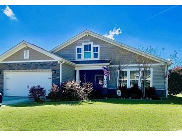 Charming craftsman-style home with stone accents and a well-manicured front lawn on a sunny day at 256 Copper Leaf Dr., Myrtle Beach, SC 29588