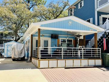 Charming light blue beach house featuring a spacious outdoor patio and appealing coastal design at 6001 - 1268 S Kings Hwy., Myrtle Beach, SC 29575