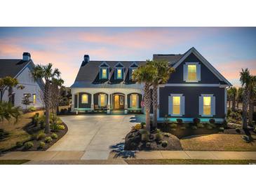 Charming home with manicured lawn, and concrete driveway, perfect for coastal living at 6121 Bolsena Place, Myrtle Beach, SC 29572