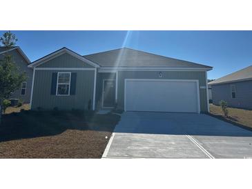 Charming single-story home featuring a two-car garage and well-maintained front yard at 636 Grateful Dr., Little River, SC 29566
