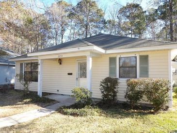 Cozy single-story home with a covered front porch, neatly trimmed shrubs, and a well-maintained yard at 6654 Wisteria Dr., Myrtle Beach, SC 29588