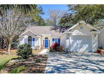 Charming single-story home with light siding, bright blue shutters, and a well-manicured front yard at 81 Safe Harbor Ave., Pawleys Island, SC 29585