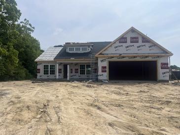 Image shows the unfinished exterior of a new construction home with an attached two-car garage at 471 Highway 348, Loris, SC 29569