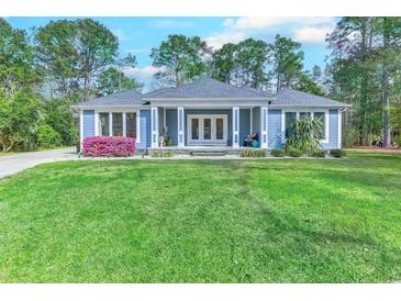 Charming one-story home with lush landscaping and inviting front porch at 138 Cooper River Rd., Myrtle Beach, SC 29588