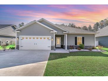 Charming one-story home with a well-manicured lawn, stone accents and a two car garage at 1470 Burriss Rd., Conway, SC 29526